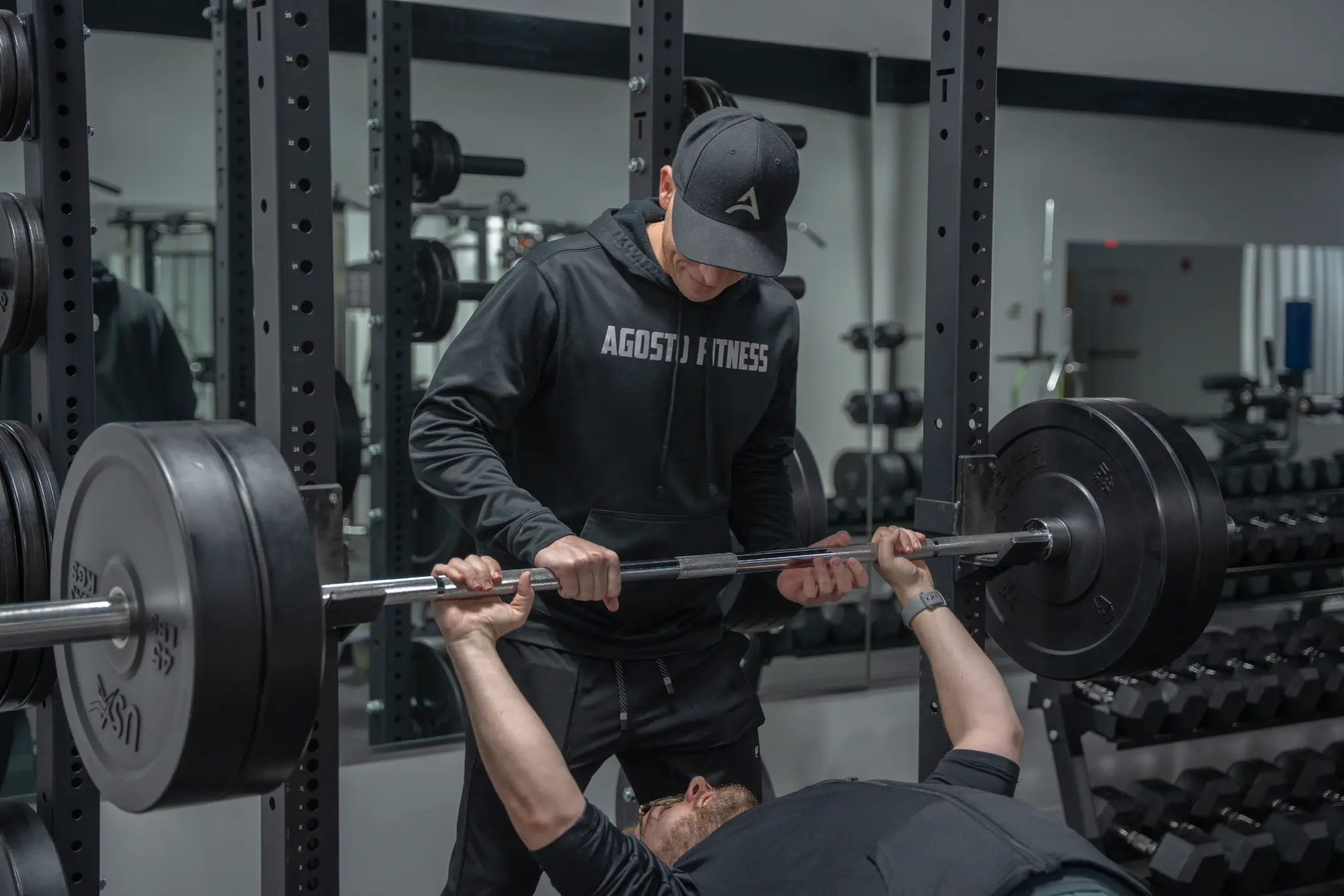 Garret Agosto spotting client on bench press at private gym in Rochester NY