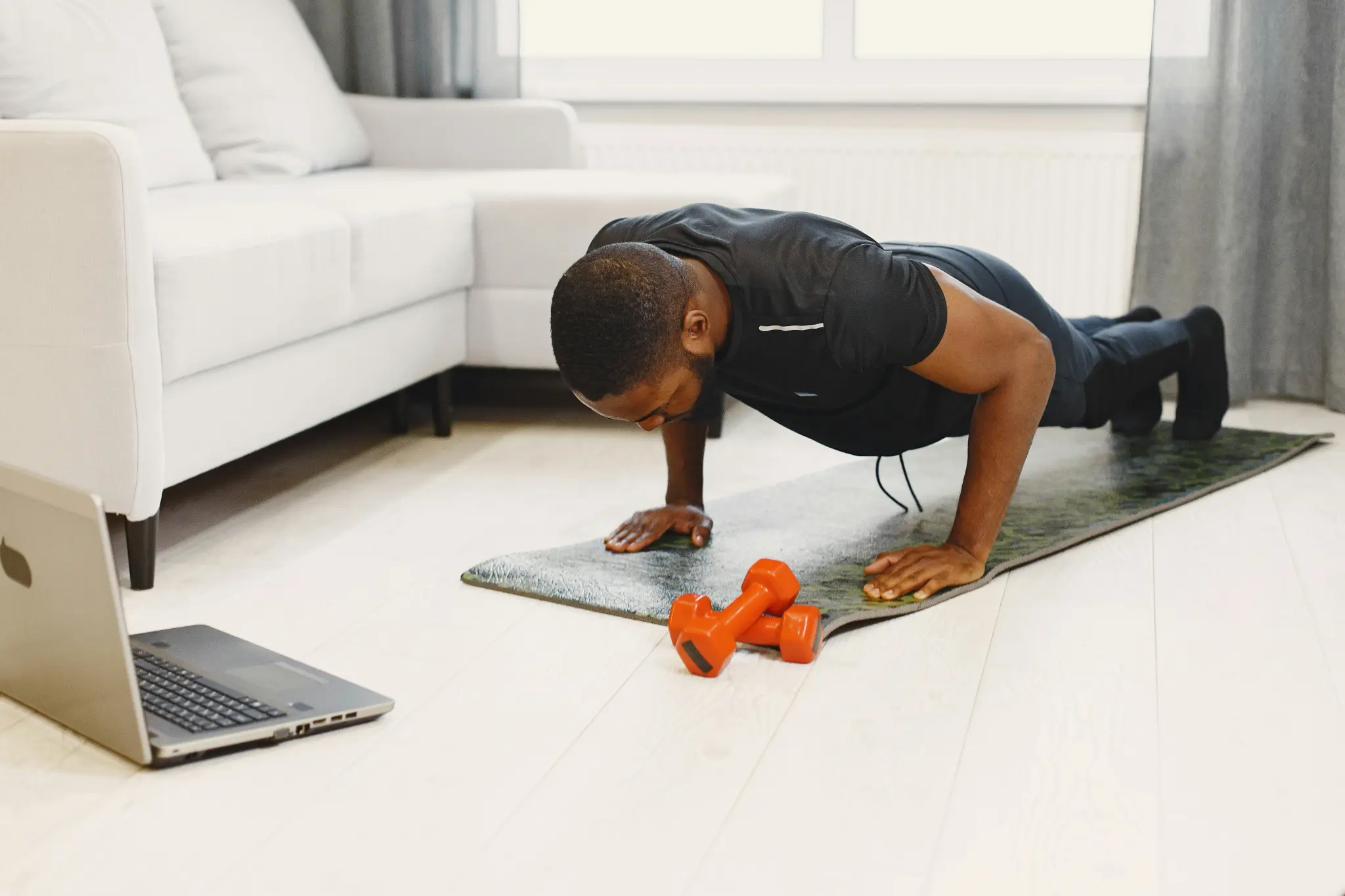Man doing pushups during virtual personal training session