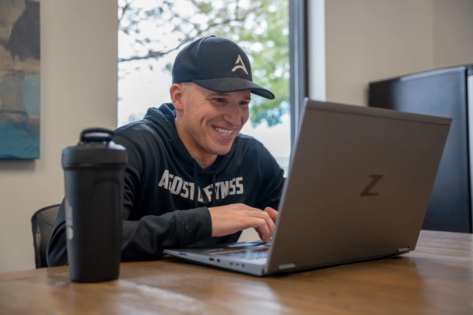 Garret Agosto coaching a virtual training client on laptop